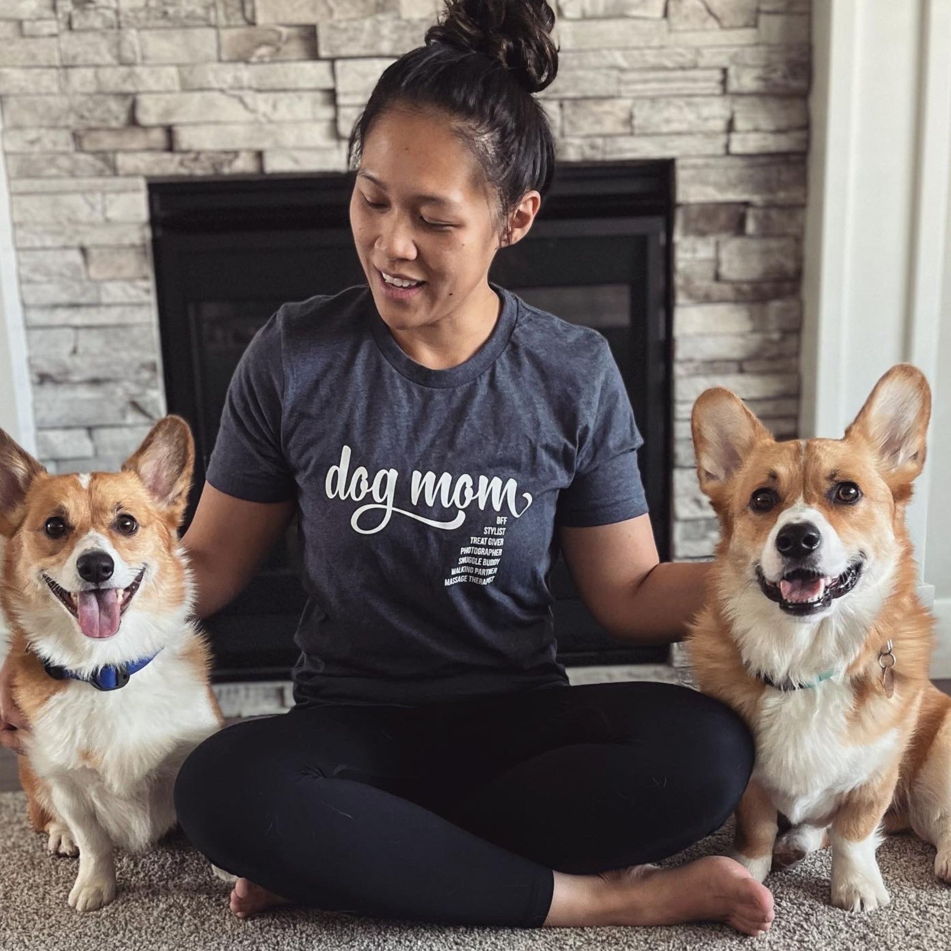Dog mom t-shirt in heather navy - featuring dog mom with corgis sitting in front of a fireplace Luv the Paw