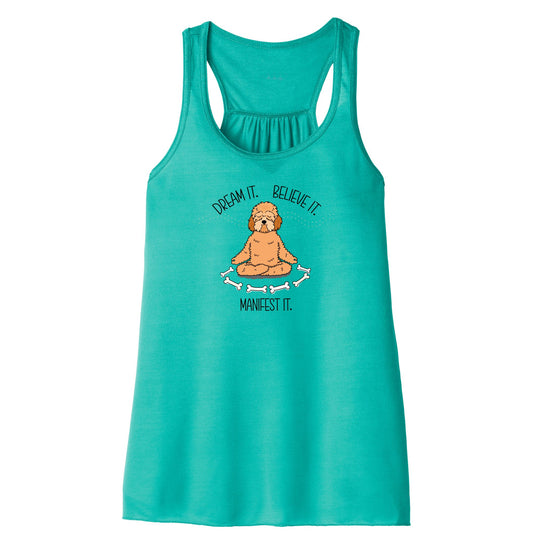 Women’s Manifest It tank top in teal featuring a meditating doodle dog with bones and the mantra “Dream it. Believe it. Manifest it.” in a soft, lightweight racerback style perfect for yoga and dog lovers.
