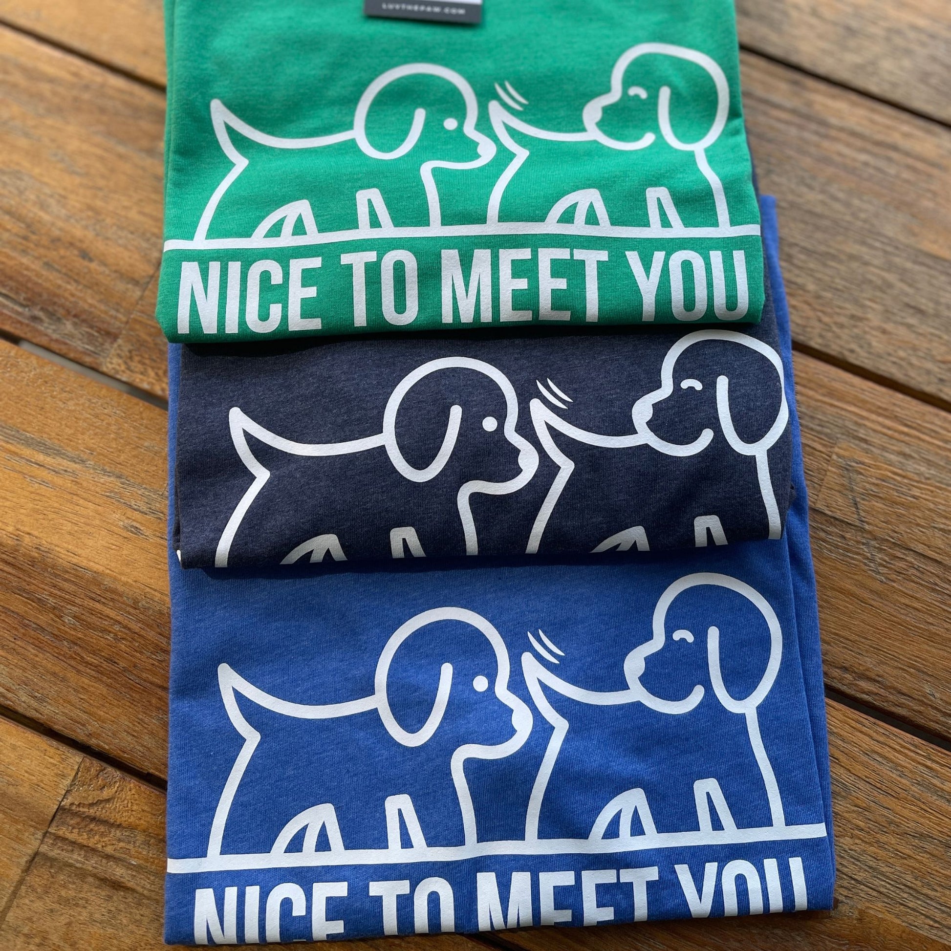 3 Funny t-shirts with dogs sniffing each other that says nice to meet you - in green, royal and navy blue
