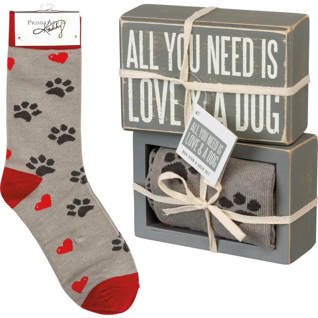 Gray socks with red hearts and black paw prints, paired with a decorative box featuring 'All You Need is Love & a Dog' text. Great Valentines Gift for Dog Lover