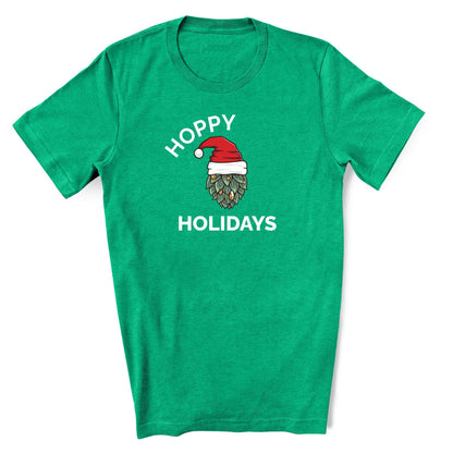 Heather kelly Green shirt that says Hoppy Holidays in white text. In the middle of the text features a hop with a santa hat. Funny Christmas shirt for beer lover