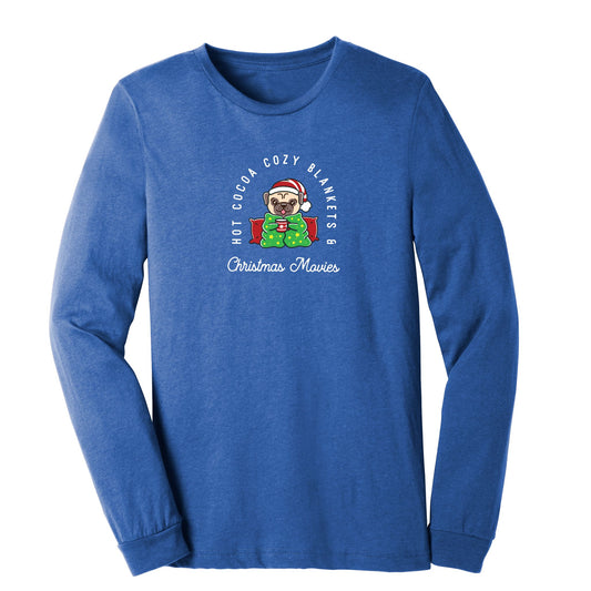 Long sleeve royal heather blue shirt with a small dog holding a coffee mug wearing a santa hat. In white text around the dog "Hot Cocoa Cozy Blankets & Christmas Movies"