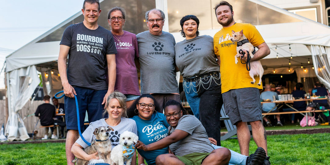 A group photo of the Luv the Paw community, showcasing their love for dogs and outdoor activities.