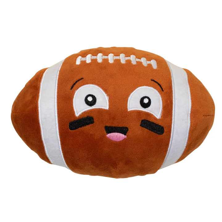 A brown plush football pillow with a cute cartoon face, featuring embroidered white stripes, white laces, and a smiling expression on a plain white background.