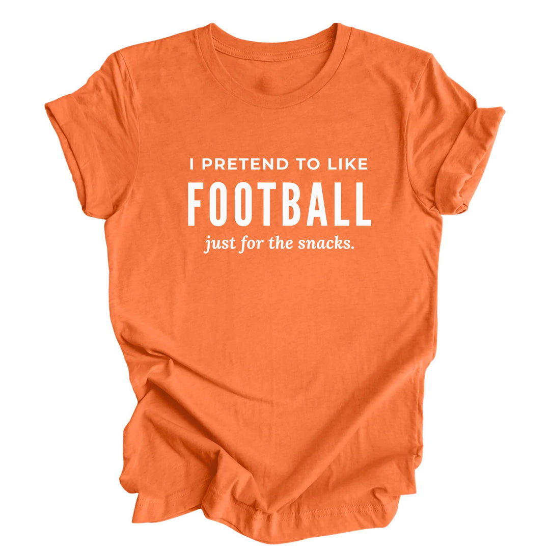 Funny football heather orange T-shirt with white lettering that reads “I Pretend to Like Football Just for the Snacks.”