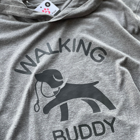 Hoodie for dog owner that says 'walking buddy' in text and in the middle a dog holding a leash in its mouth