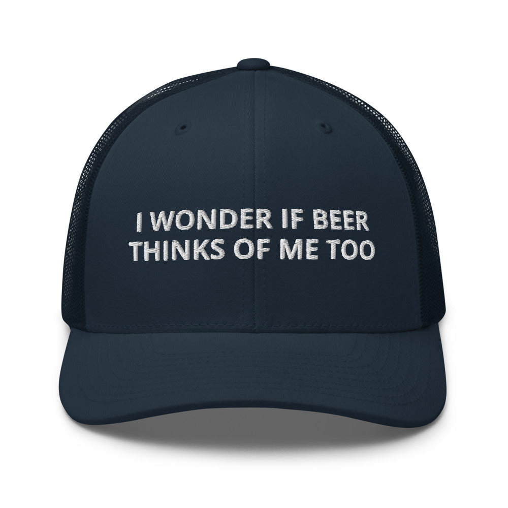 Navy blue cap with white text 'I WONDER IF BEER THINKS OF ME TOO' on a white background